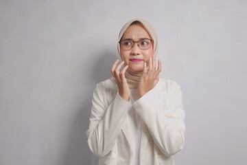 Woman in a White Blazer and Hijab Looking to the Side