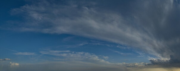 Russia, south of Western Siberia. Panoramic view of the evening sky with the setting sun and colorful clouds.