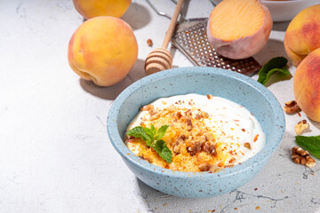 Frozen Shaved Peaches and Cream Dessert, Healthy summer snack with cream or yogurt and shaver...