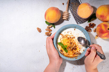 Frozen Shaved Peaches and Cream Dessert, Healthy summer snack with cream or yogurt and shaver...