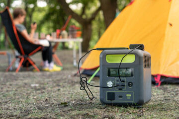 Portable power station with lithium ferrophosphate battery  charging electronic  devices used at a...