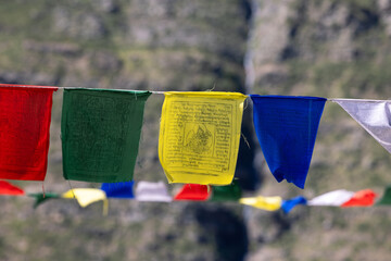 Lung ta prayer flags hang along a mountain path