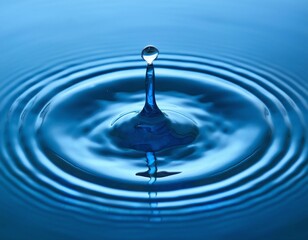 Droplet Falling into Water Surface Creating Ripples