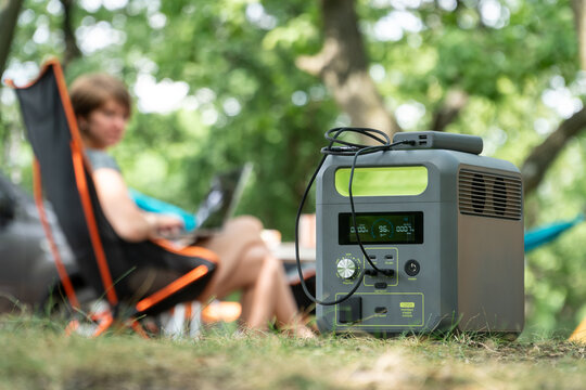 Portable power station with lithium ferrophosphate battery  charging electronic  devices used at a wild camp site.