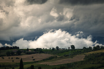 Spring view of landscapes of region Marche near Ancona during sunset. Green waves hills and lone...
