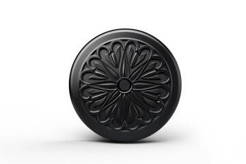 A black object with a flower design on it. The flower design is very detailed and intricate. The object is round and has a shiny surface