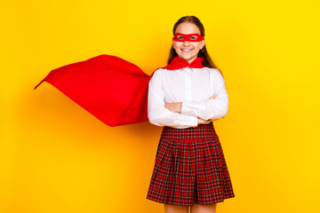 Photo portrait of charming teen pupil girl confident crossed hands superhero wear trendy uniform isolated on yellow color background