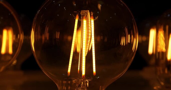 Light bulbs with big yellow filaments inside in vintage style. Cinema 4K 60fps video