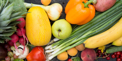 Plant background with ripe fruits, vegetables, berries and herbs, top view