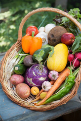 A large wicker basket with various fruits and vegetables