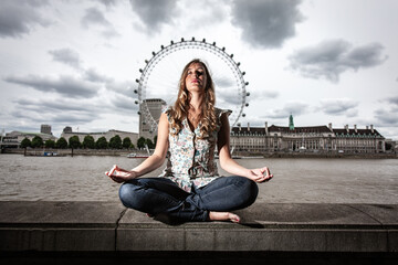 London Zen. A candid portrait of a young girl sitting in he lotus position on location in London...