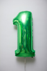 green foil number 1 balloon on white background