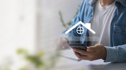 A person uses a smartphone to search for real estate online, highlighting digital home search...