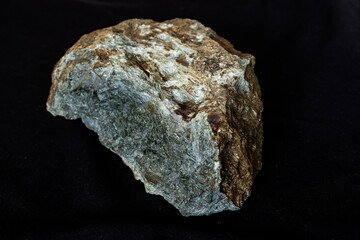 A Komatiite specimen from South Africa, against a black background,