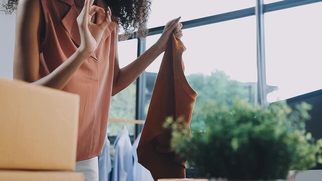 Designer concept.The dressmaker is designing an evening dress in the room.Asian clothing designers are measuring sample sizes to prepare evening gowns for important customer orders