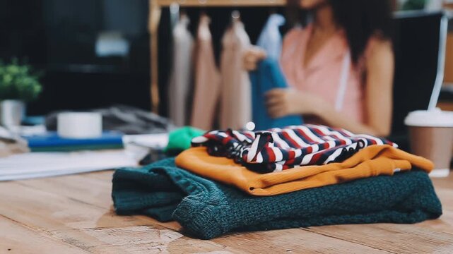 Designer concept.The dressmaker is designing an evening dress in the room.Asian clothing designers are measuring sample sizes to prepare evening gowns for important customer orders