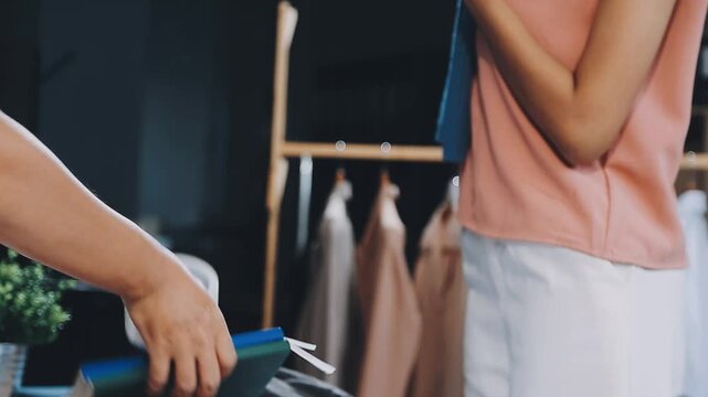 Designer concept.The dressmaker is designing an evening dress in the room.Asian clothing designers are measuring sample sizes to prepare evening gowns for important customer orders