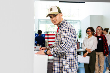 Man standing in voting booth, voting. Concept of USA elections, patriotism, support