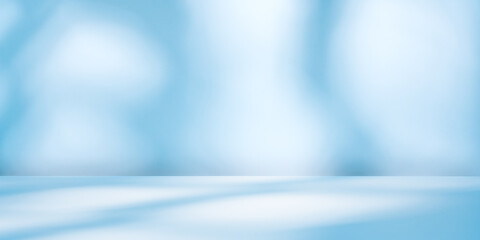 Blue wall with round light reflections and empty table. Panoramic background  for presentation, branding products, cosmetics food or jewelry.