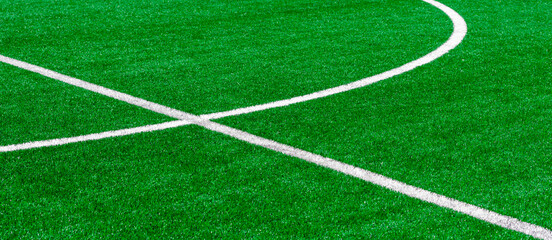 Green synthetic grass sports field with white line shot from above. Soccer, hurling, lacrosse, rugby, football, baseball sport concept