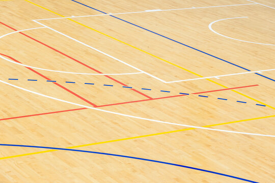 Wooden floor basketball, badminton, futsal, handball, volleyball, football, soccer court. Wooden floor of sports hall with marking lines on wooden floor indoor, gym court