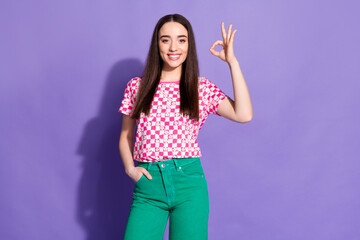 Fototapeta premium Portrait of nice young woman show okey wear checkered t-shirt isolated on violet color background