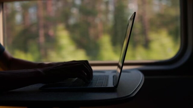 Freelancer working with laptop in the train. Work anywhere, anytime.