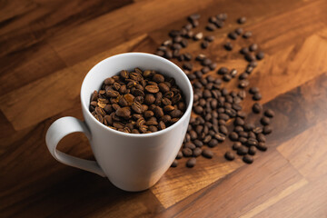 white mug full of roasted coffee bean, arabica wash process, medium roasted