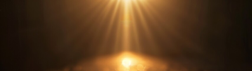 Naklejka premium Golden light beam spotlight. A bright golden spotlight shines on a dark background, creating a dramatic and atmospheric effect.
