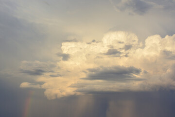 a stormy cloud with a rainbow in the sky 