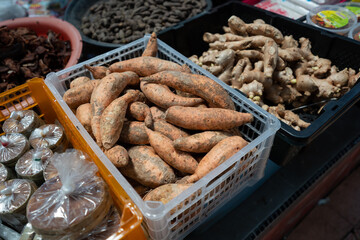 Bucket filled with sweet potatoes for sell at market.