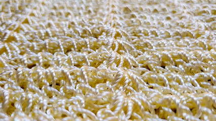 Close up golden beige yarn thread as abstract background