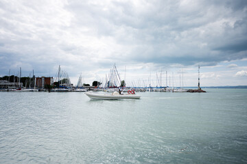 Scenic view of marina with boats and yachts under cloudy sky in Siofok, Balaton lake, Hungary.