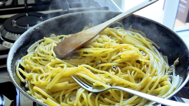 Conceptual home cooking video with cooking by woman hands of Italian spaghetti pasta with sea clams vongole mollusc. Gourmet to eat. Classic Italian seafood dish