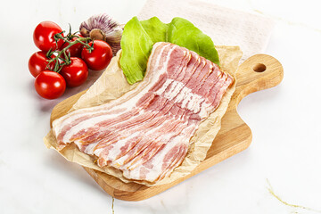 Sliced pork bacon oved board