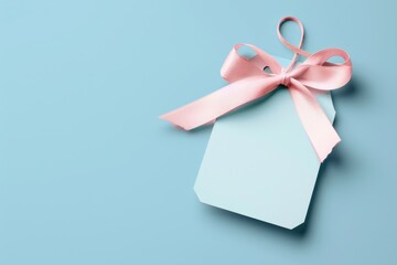 A blue gift box wrapped with a pink ribbon against a blue background