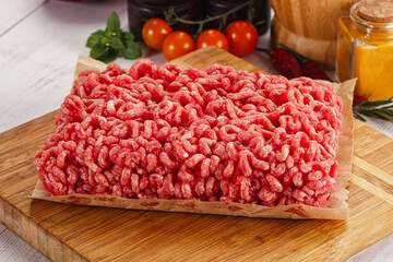 Raw minced beef meat over board