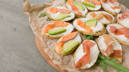 bruschetta with salmon and avocado, dietary appetizer or snack