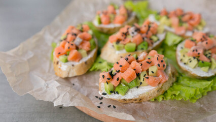 bruschetta with salmon and avocado, dietary appetizer or snack