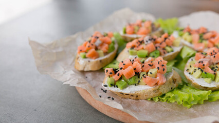Canapés with salmon and avocado, dietary appetizer or snack