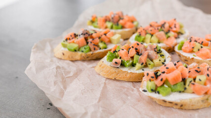 Canapés with salmon and avocado, dietary appetizer or snack