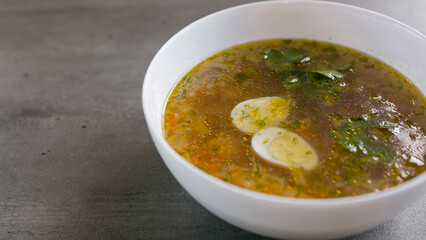 chicken broth in a white plate, photo above