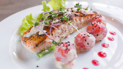 grilled salmon fillet with creamy sauce and tomatoes