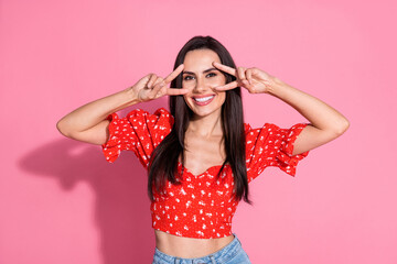 Portrait of smiling beautiful gorgeous lovely young woman in retro red blouse cover face double v...