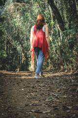 Brazilian Woman with a red sweater,  having a walk in The Botanic Garden in São Paulo, Brazil.