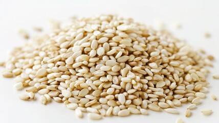 Obraz premium Front view of a wooden scoop filled with Organic White Sesame seeds (Sesamum indicum) or Til. Isolated on a white background. 