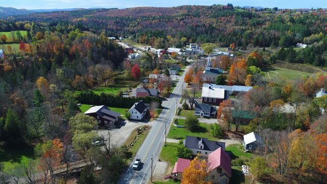 Stationary Drone View of Classic New England Village in Autumn With Cars and Trucks - East Burke, Vermont