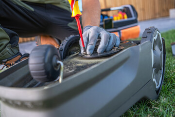 Lawn Mower Maintenance at Home Workshop With Tools on a Sunny Day
