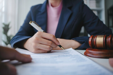 Lawyer is signing a last will and testament during a meeting with a client in their office