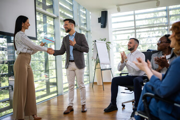 Happy young man employee excited by unexpected money bonus in envelope from boss